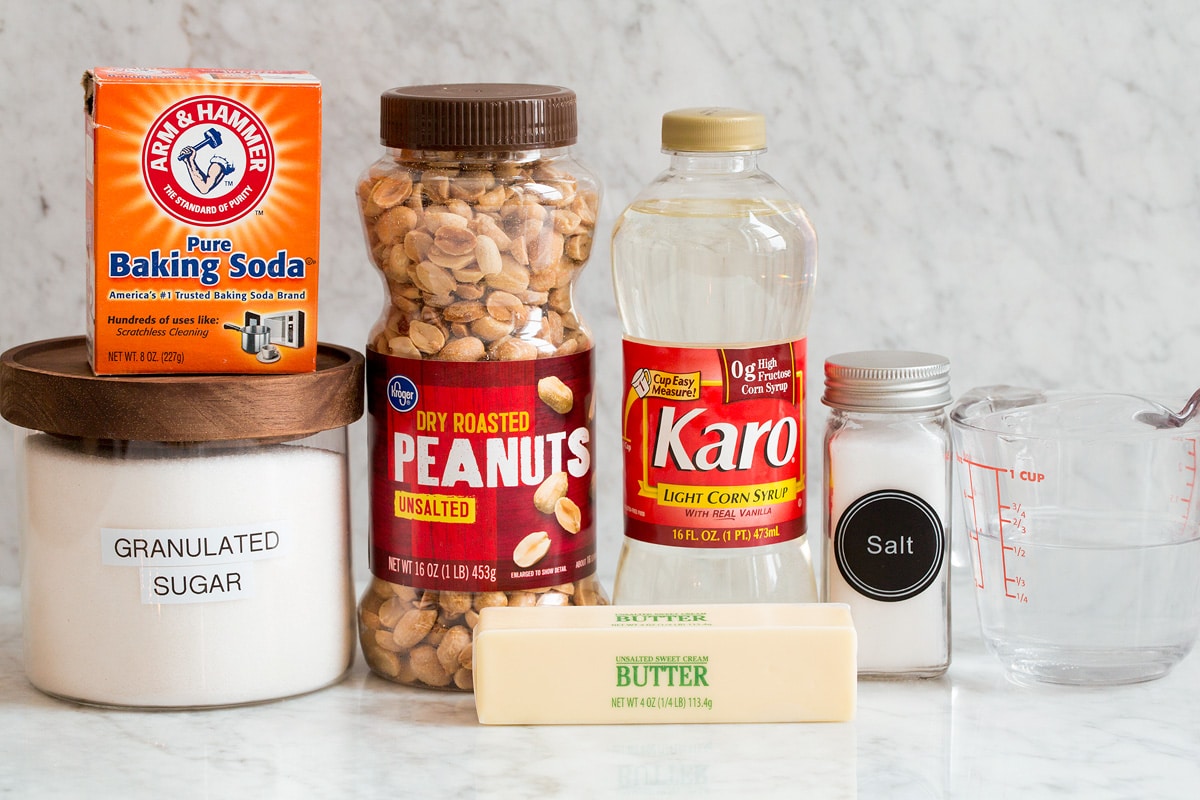 Peanut Brittle Photo of ingredients used to make peanut brittle. Includes sugar, baking soda, peanuts, butter, corn syrup, salt and water.