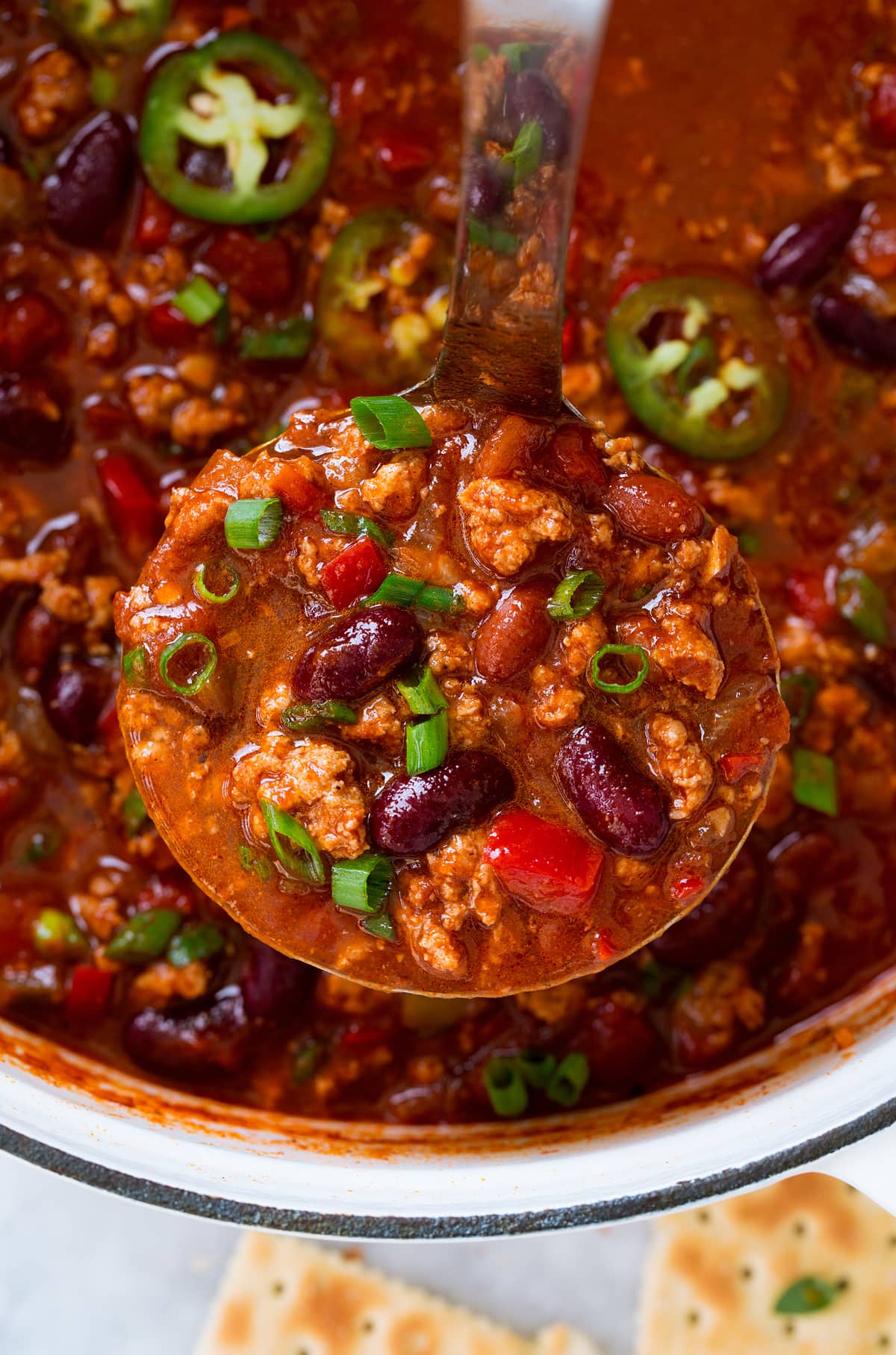 Turkey Chili Close up photo of ladle filled with turkey chili.