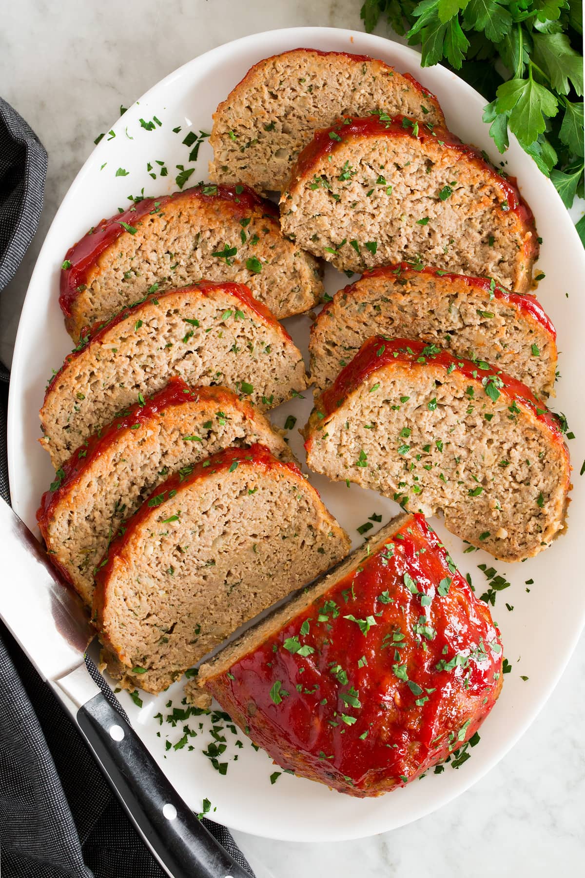 Turkey Meatloaf Photo showing slices of turkey meatloaf shown overhead on a white platter.