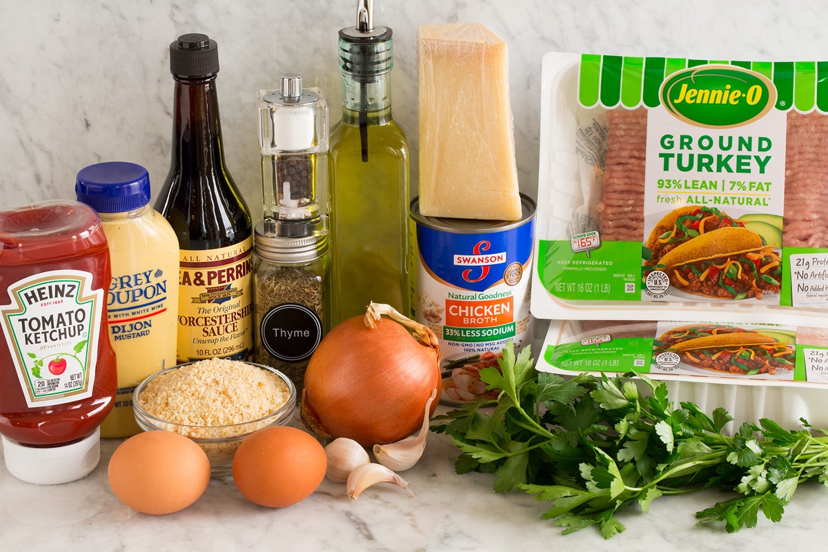 Turkey Meatloaf Photo of ingredients used in turkey meatloaf. Includes ground turkey, parsley, parmesan, chicken broth, olive oil, yellow onion, garlic cloves, eggs, bread crumbs, thyme, salt and pepper, Worcestershire, dijon, ketchup.