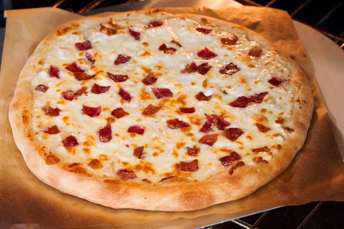 Chicken Alfredo Pizza Photo of alfredo pizza being baked in the oven.