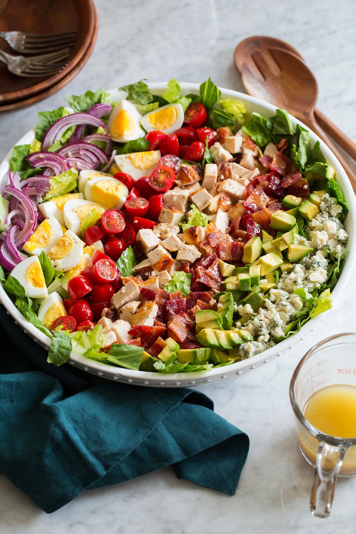 Cobb Salad Cobb salad shown from the side on a marble surface.