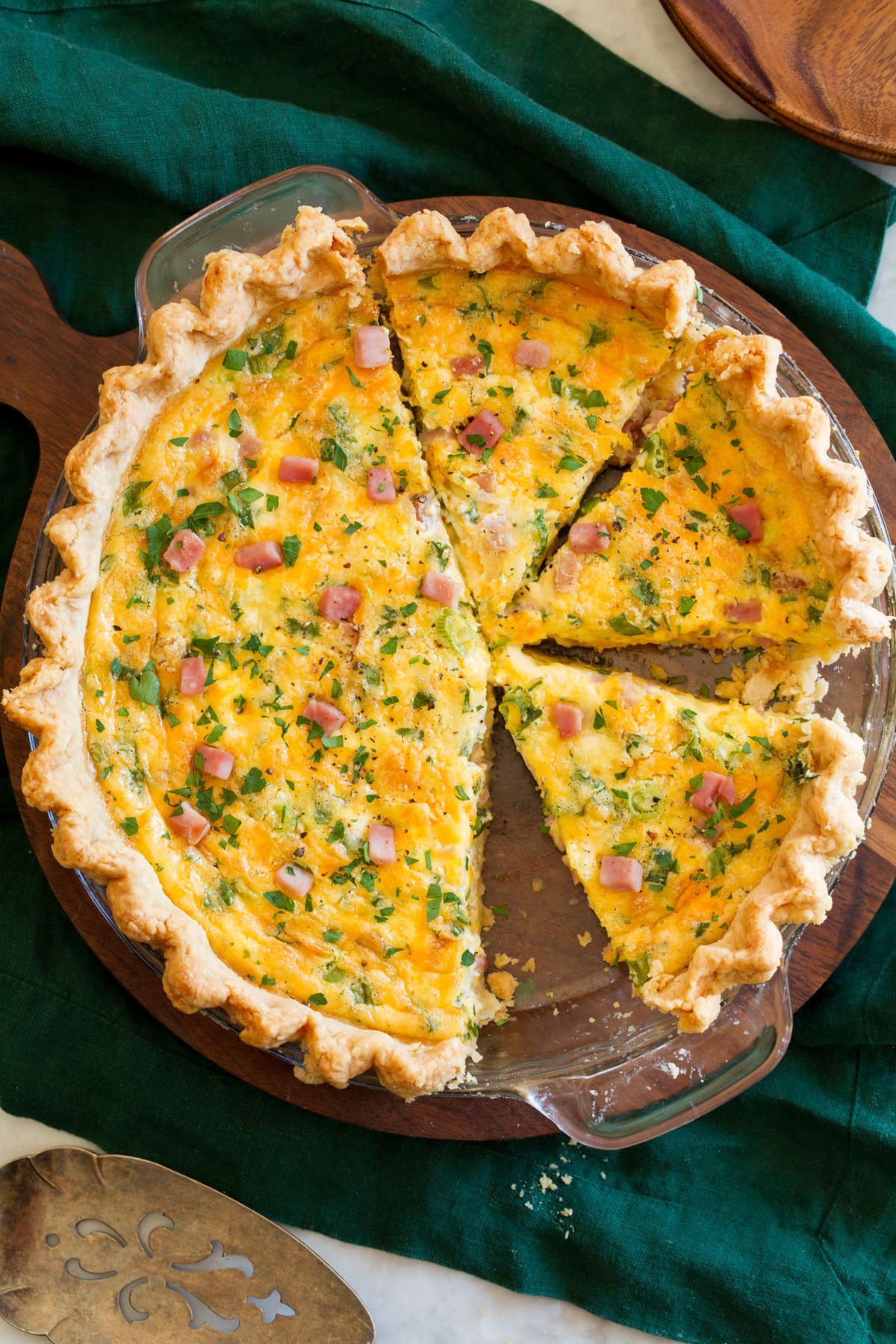 Quiche Photo of whole baked quiche sliced.