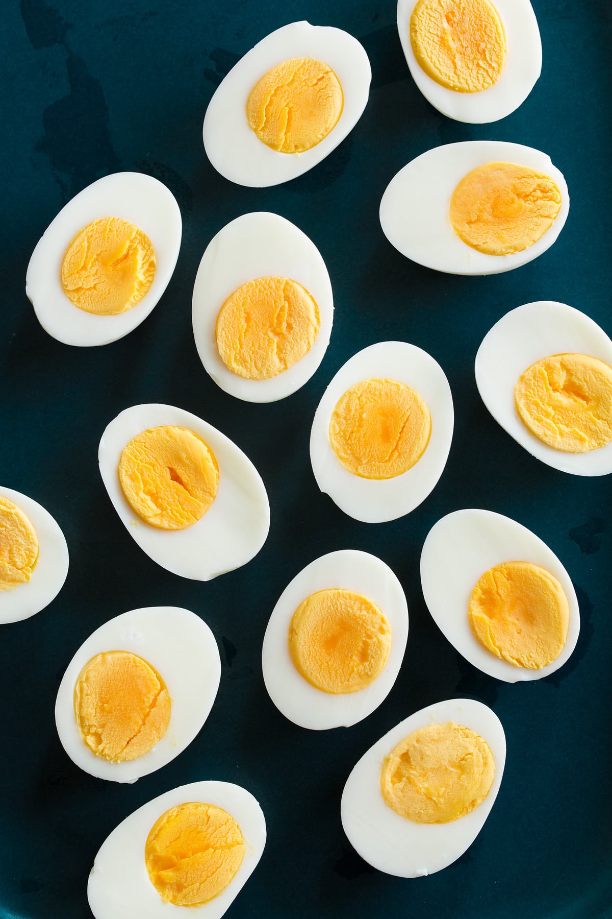 Steamed Eggs Overhead photo of steamed eggs cut in half on a blue platter.