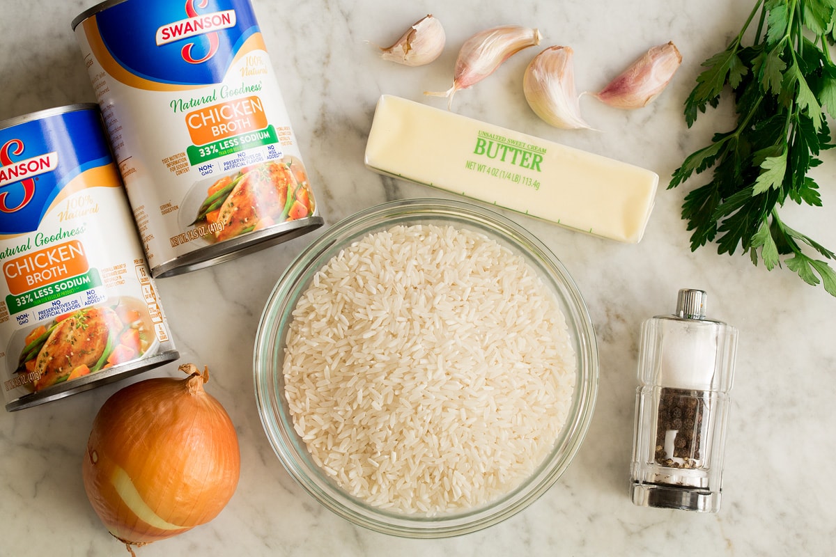 Garlic Butter Rice Photo of ingredients needed to make garlic butter rice. Includes white rice, chicken broth, onion, butter, garlic, parsley, salt and pepper.