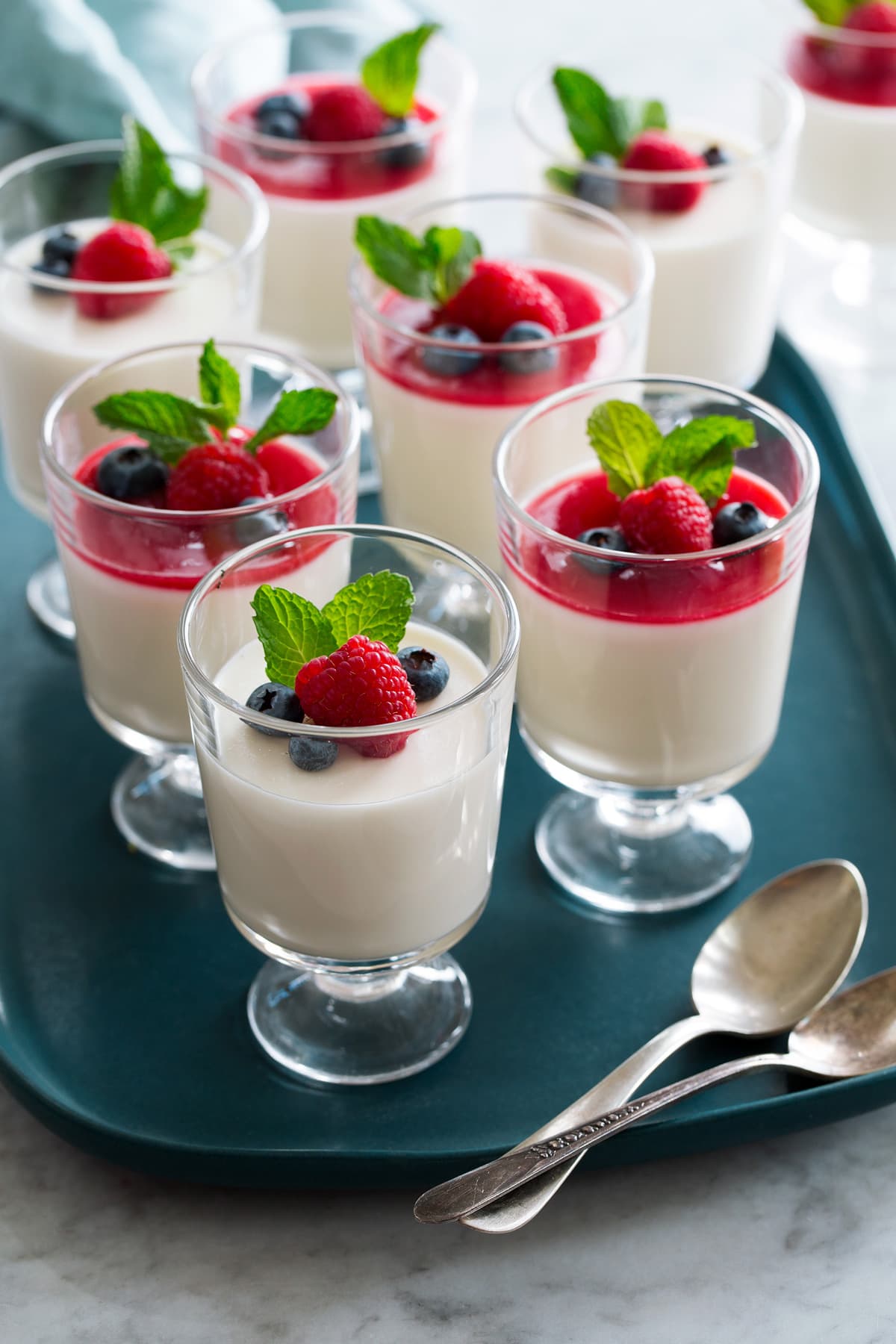 Panna Cotta Photo: Eight servings of panna cotta shown in glass dessert cups.