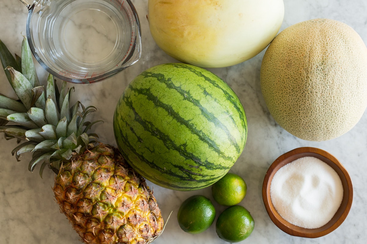 Aqua Fresca Photo: Ingredients used to make aqua fresca. Includes watermelon, cantaloup, honeydew, pineapple, limes, and sugar.