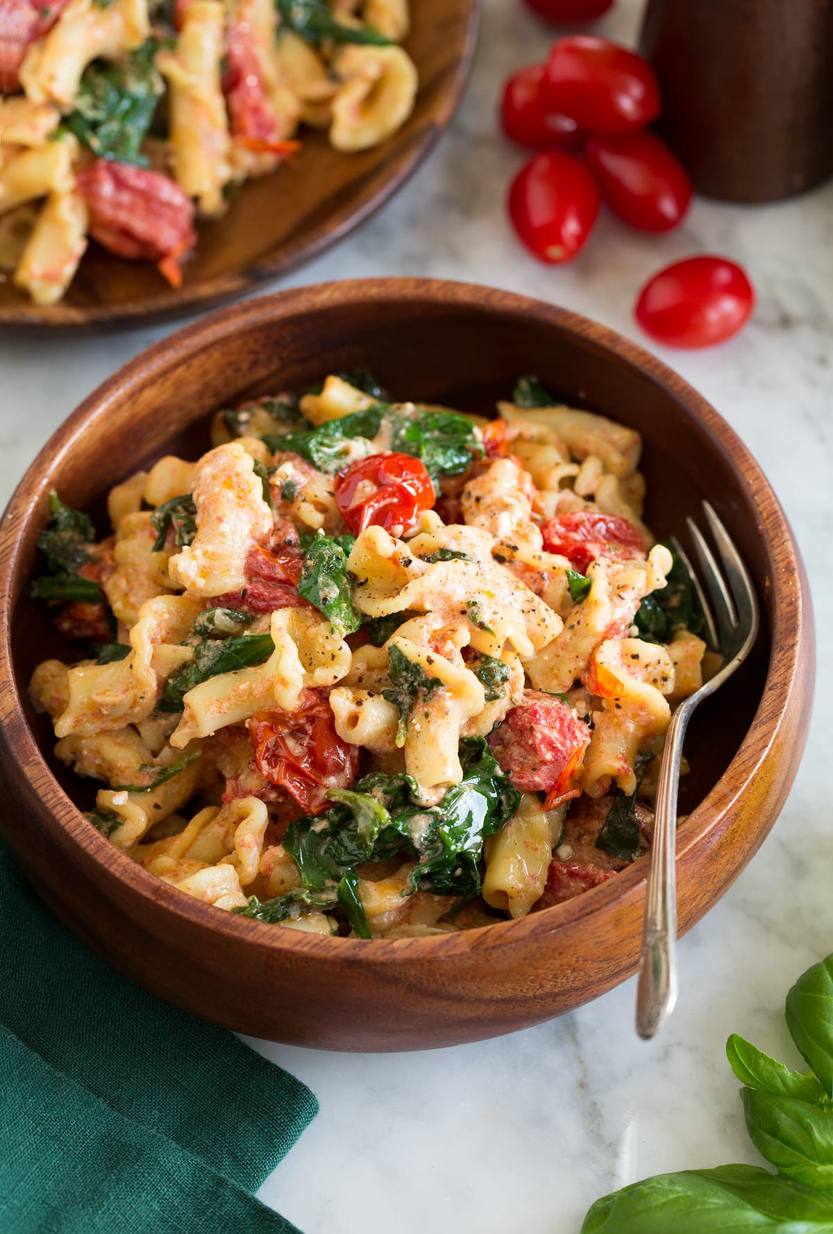 Baked Feta Pasta Photo: Serving of baked feta pasta shown in a wooden bowl.