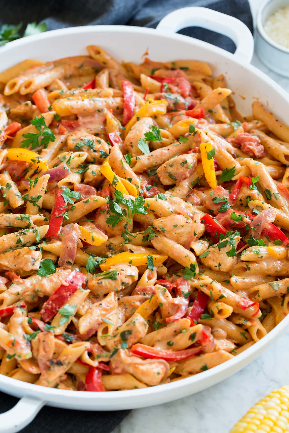One Pot Cajun Chicken Pasta Photo: One pot cajun chicken pasta shown close up in a white pan from the side.