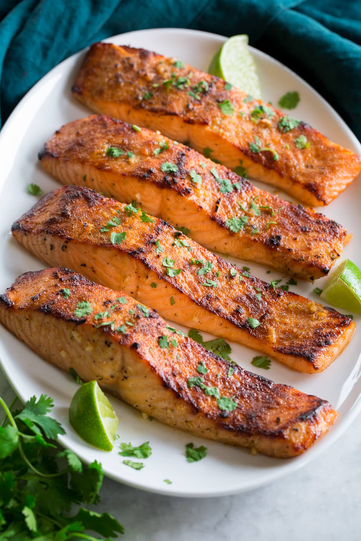 Broiled Salmon Broiled Salmon shown on a serving platter in a row of four.