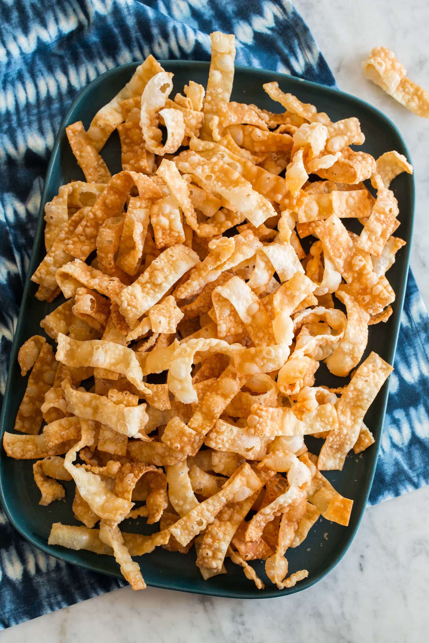 Fried Wonton Strips Overhead photo of crispy wonton strips on a rectangular platter.