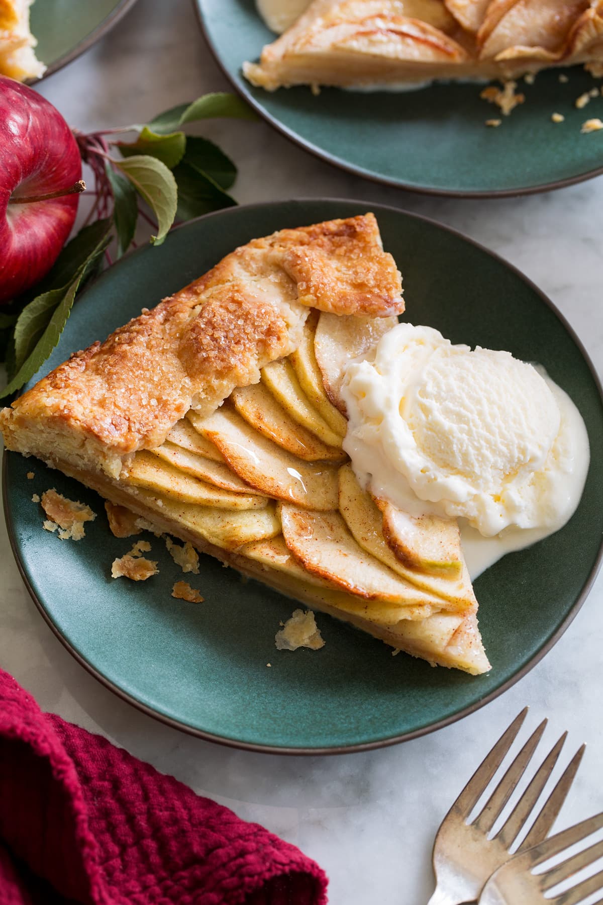 Apple Galette Slice of apple galette shown served with ice cream on a small green dessert plate.