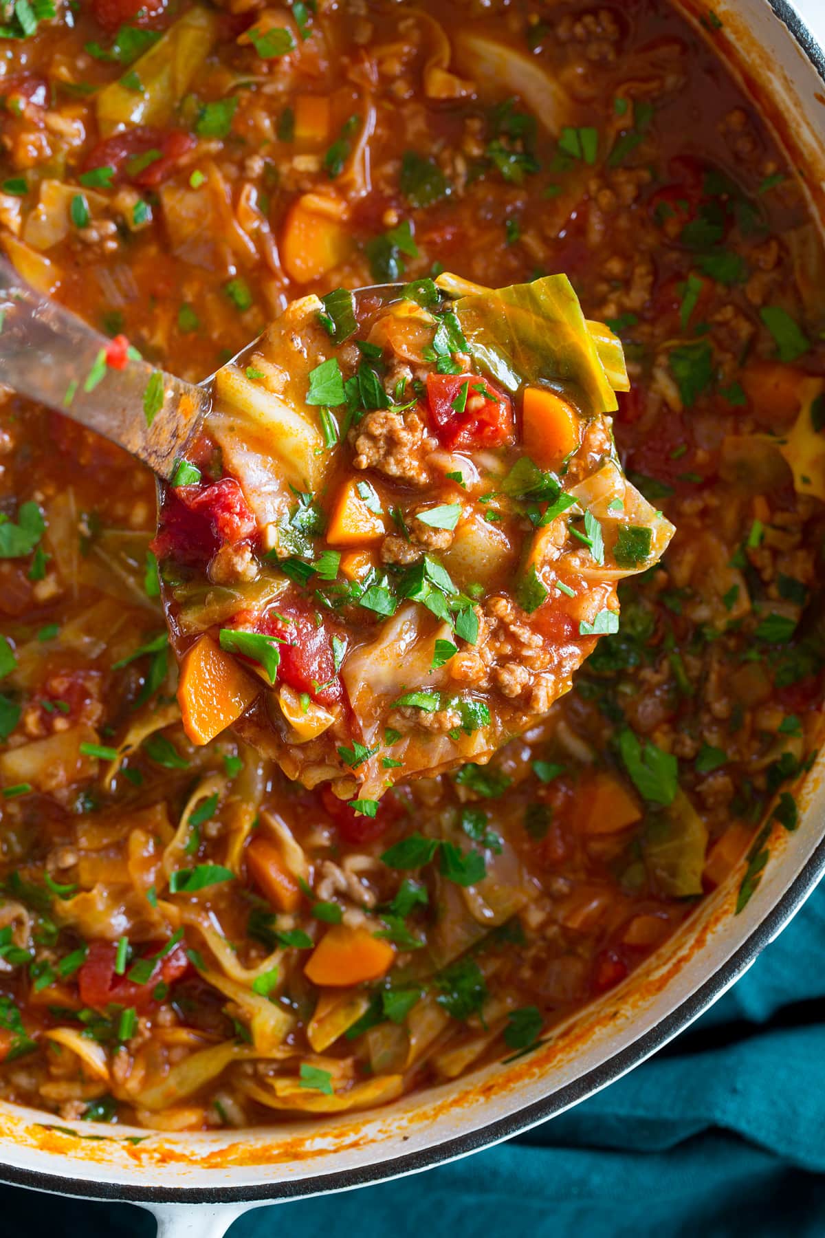 Cabbage Roll Soup Close up photo of laddle full of cabbage soup.