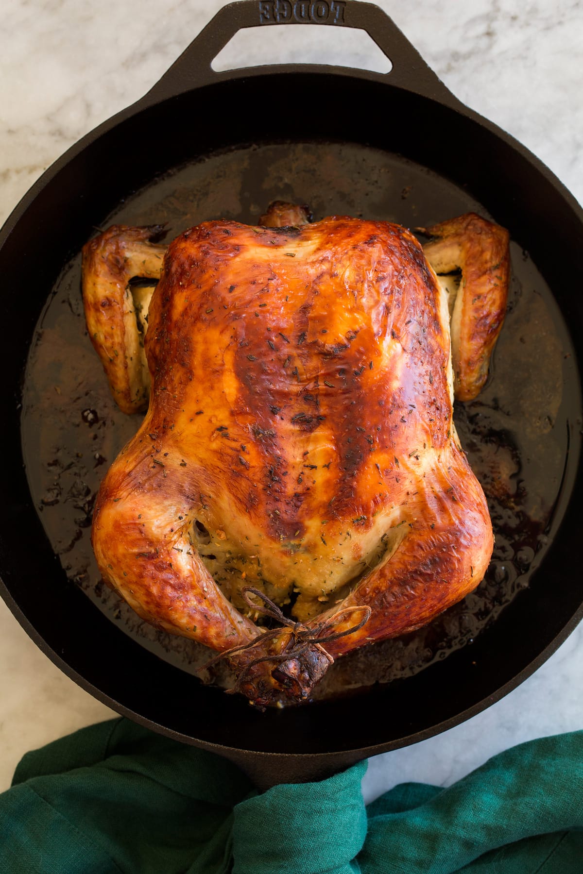 Buttermilk Roast Chicken Whole brined and roast chicken shown overhead in a cast iron skillet.