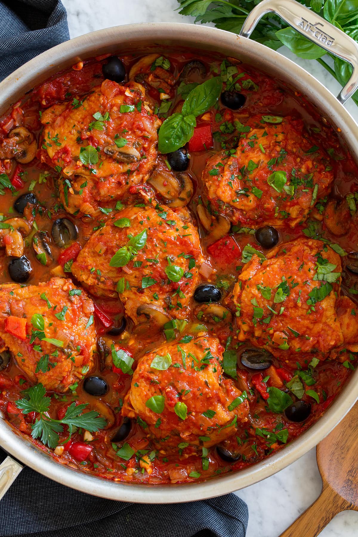 Chicken Cacciatore Overhead photo of chicken cacciatore shown in a stainless steel saute pan.
