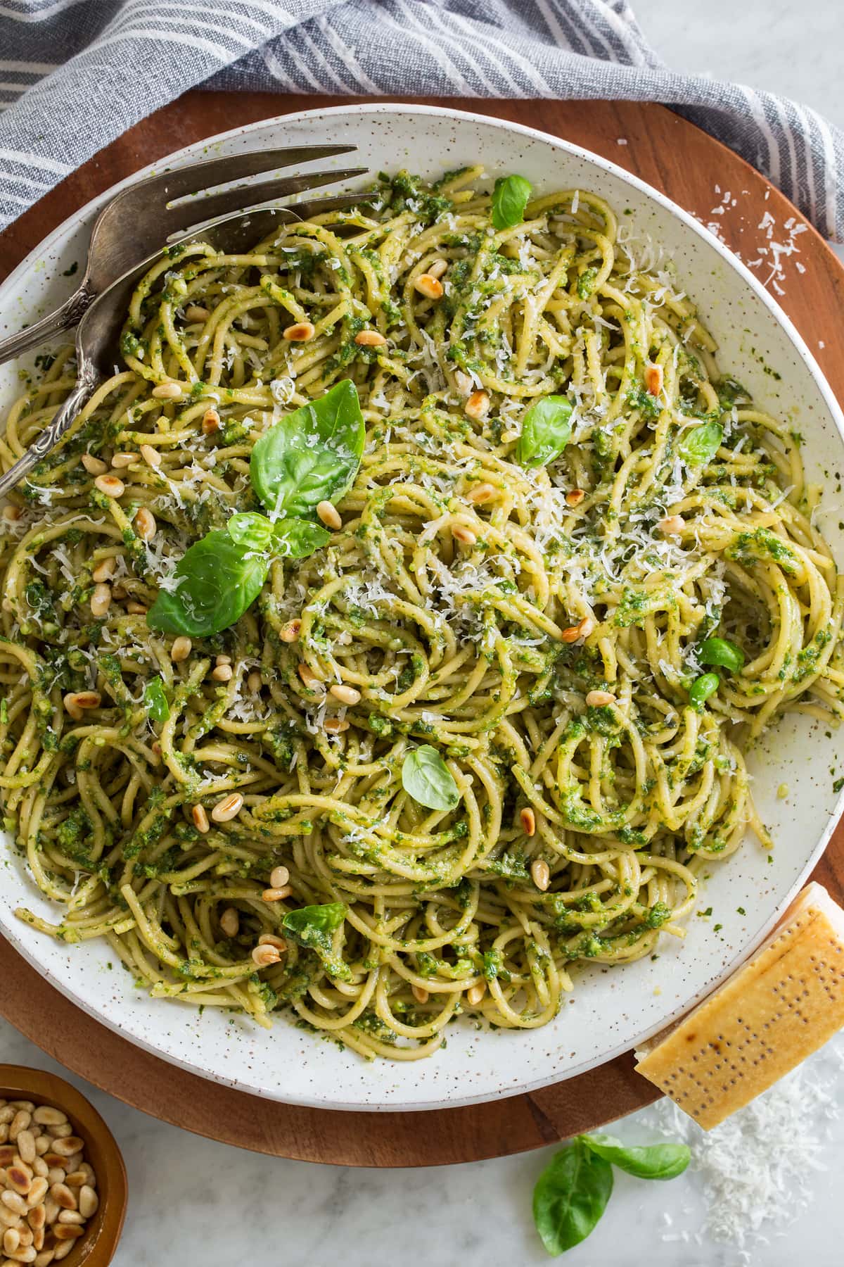 Pesto Pasta Overhead photo of pesto pasta garnished with basil leaves and toasted pine nuts.
