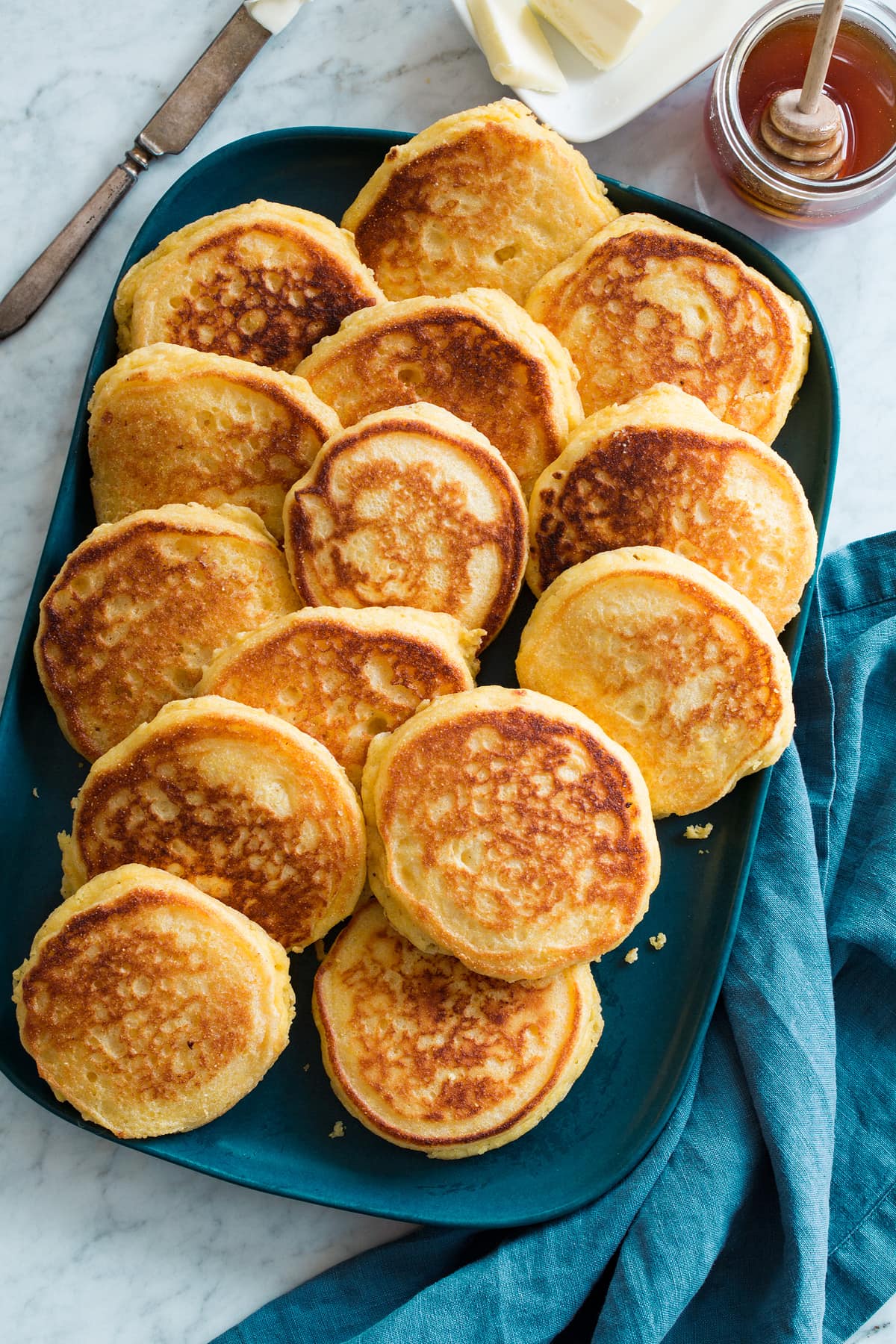 Johnny Cakes - Hoecakes Overhead photo of blue platter full of stacked Southern hoecakes.
