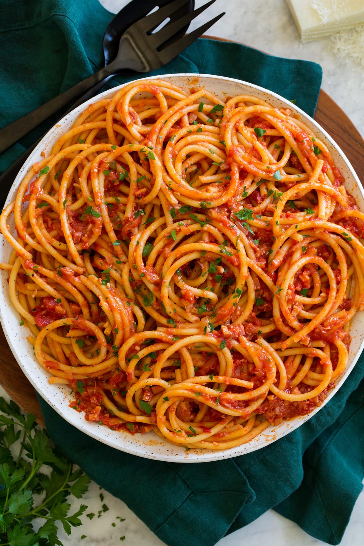 Bucatini all'Amatriciana Overhead photo of cooked bucatini pasta with tomato sauce.