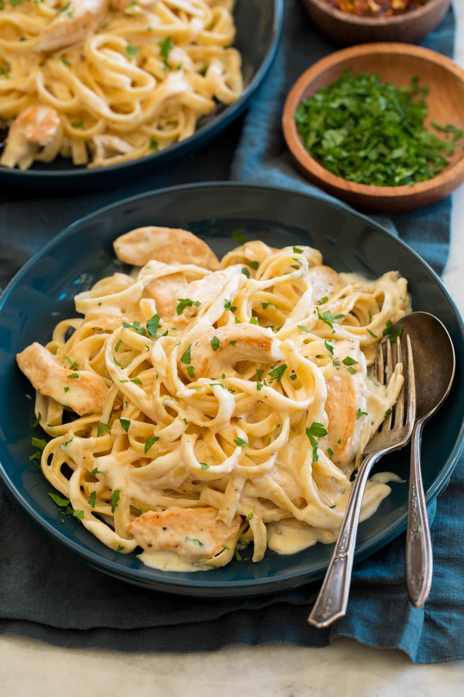 Chicken Alfredo Chicken alfredo in a blue pasta bowl.