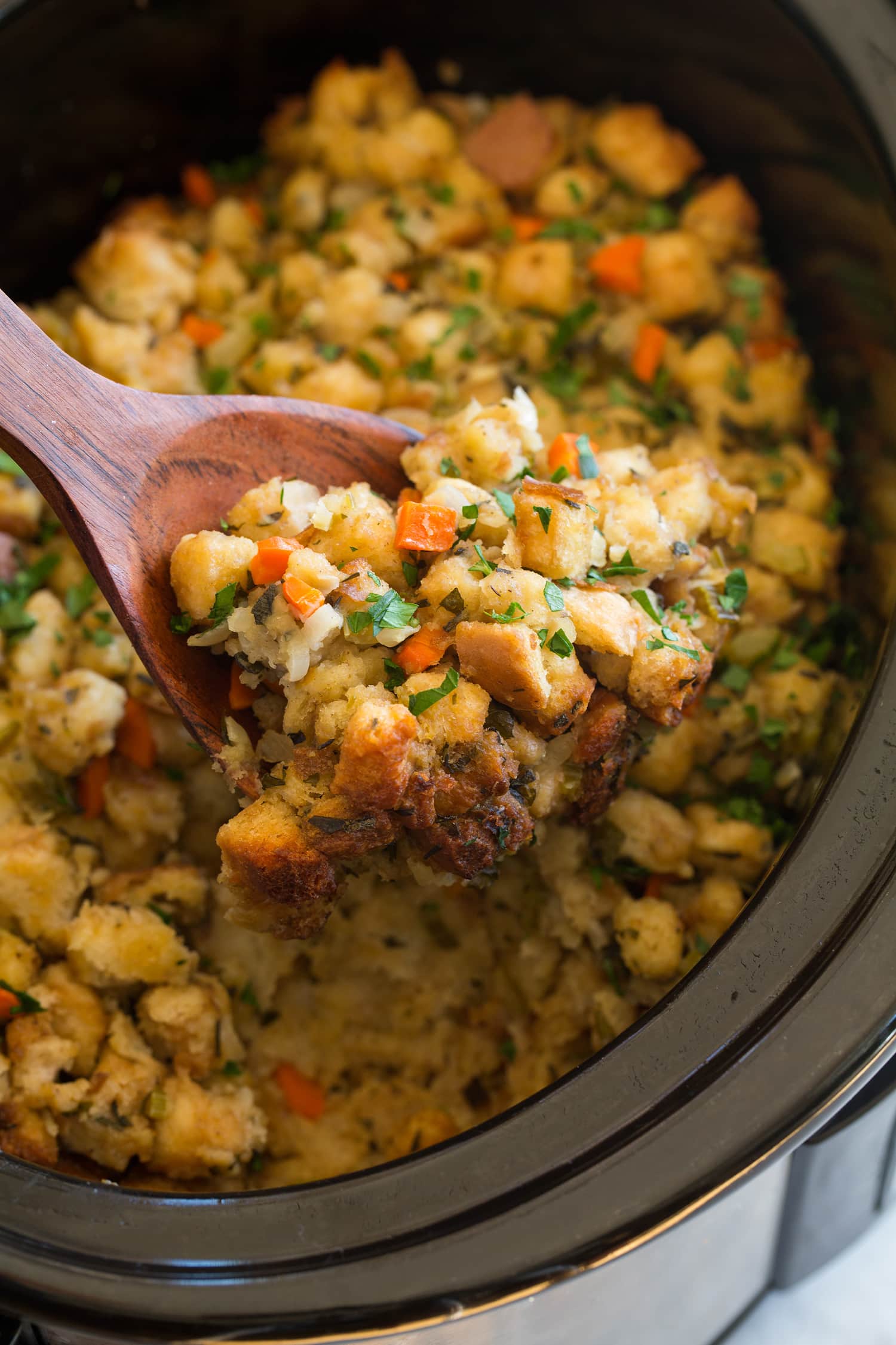Crockpot Stuffing Scoop of stuffing lifted from slow cooker.