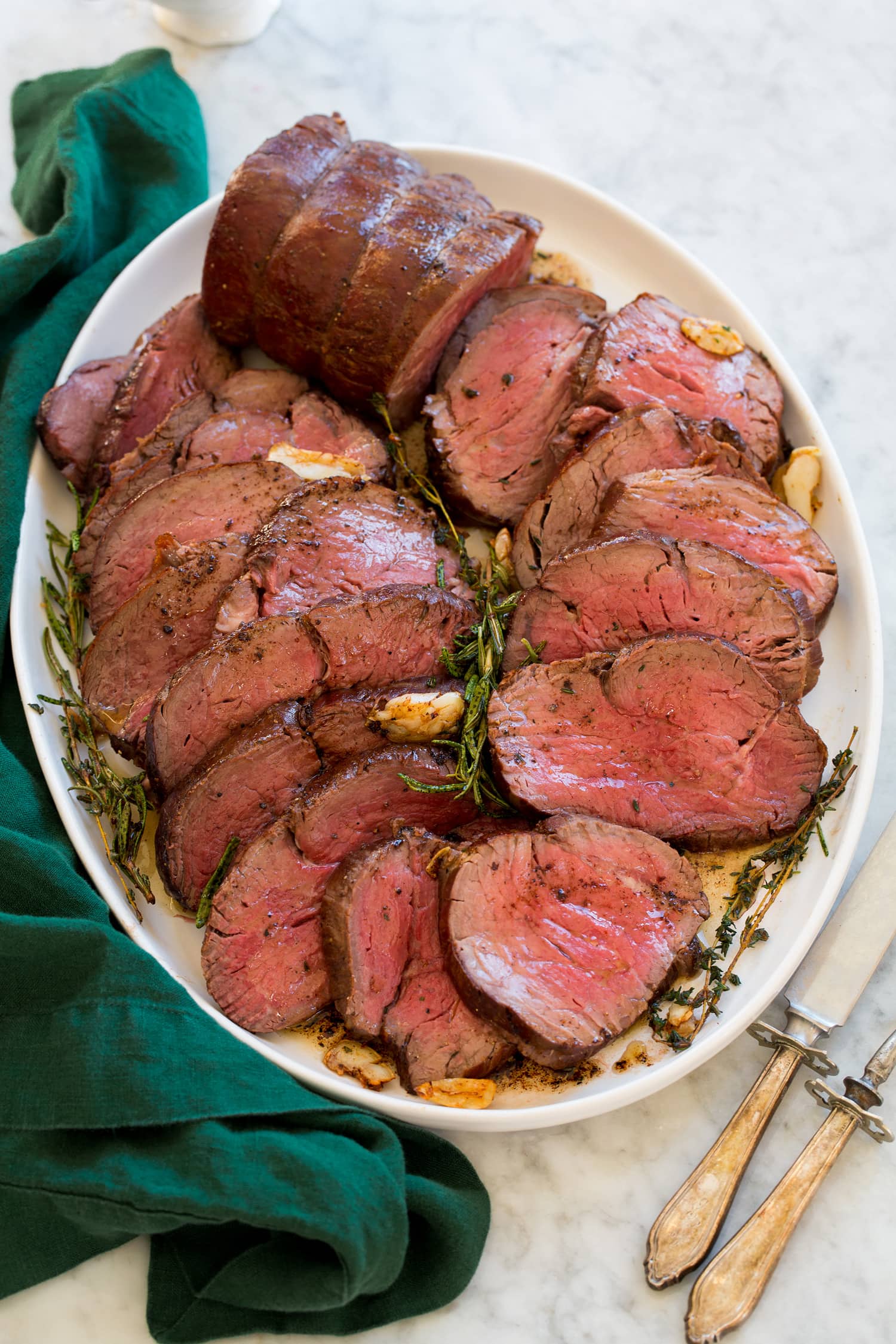 Beef Tenderloin Platter with beef tenderloin slices cooked medium rare overlapping on each other.