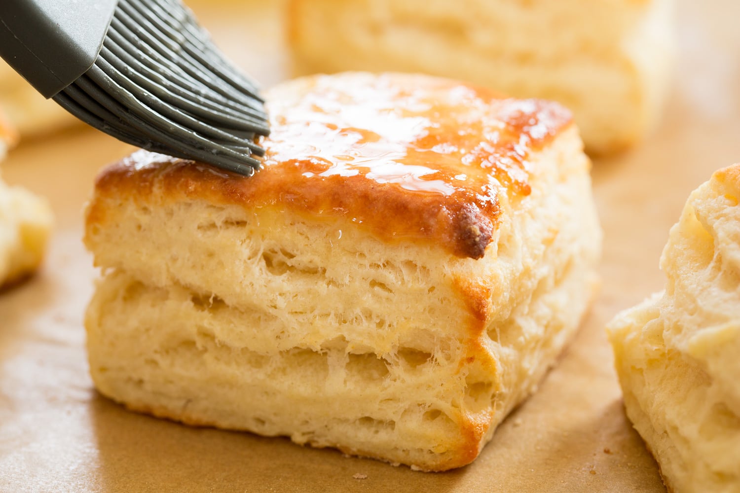 Biscuits and Gravy Brushing baked buttermilk biscuits with melted butter.