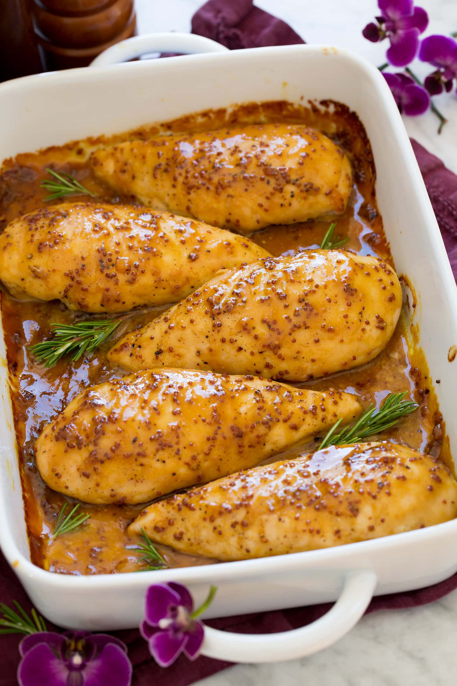 Baked Honey Mustard Chicken Honey mustard chicken in a baking dish lined up in a row.