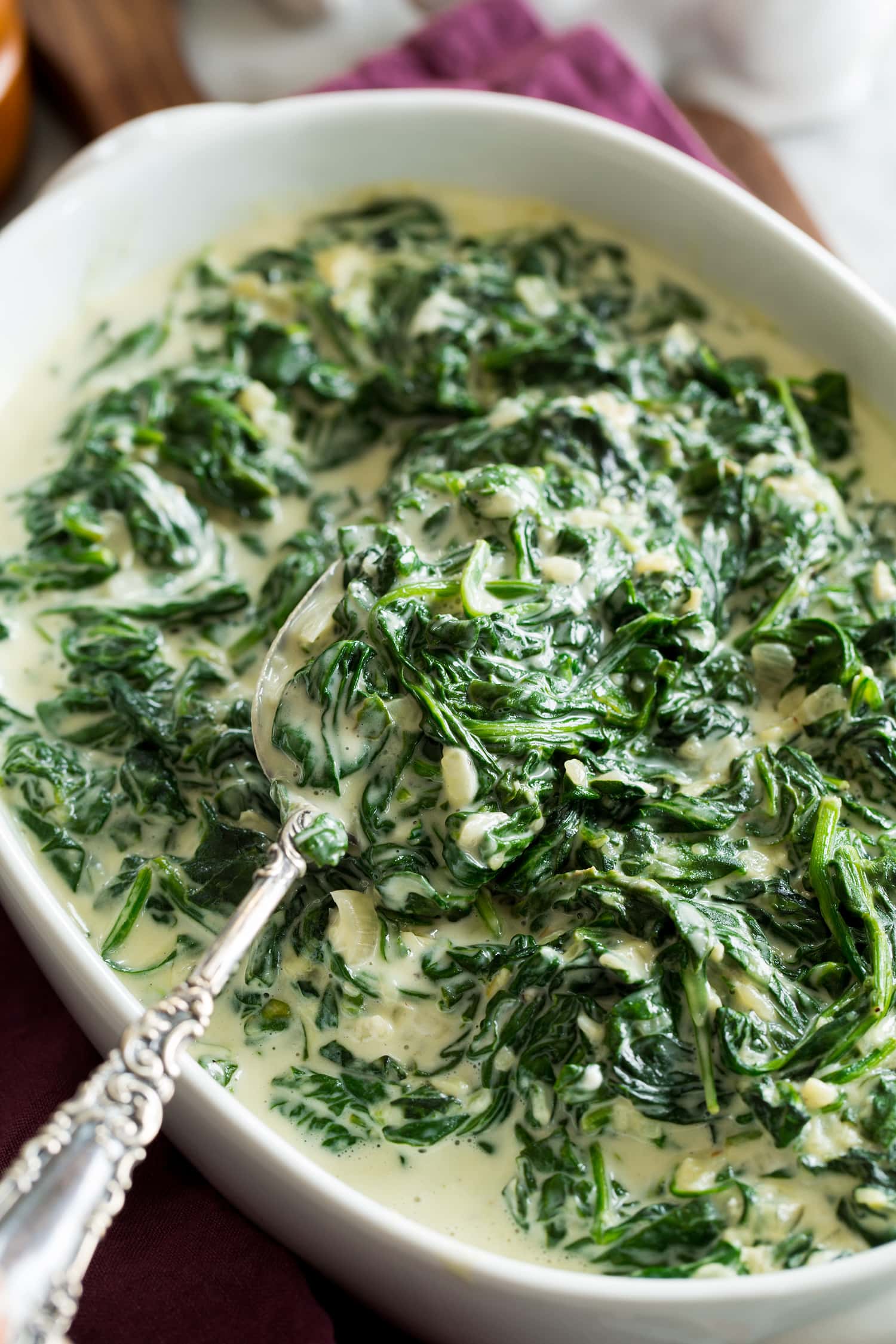 Creamed Spinach Close up photo of cooked spinach with cream.