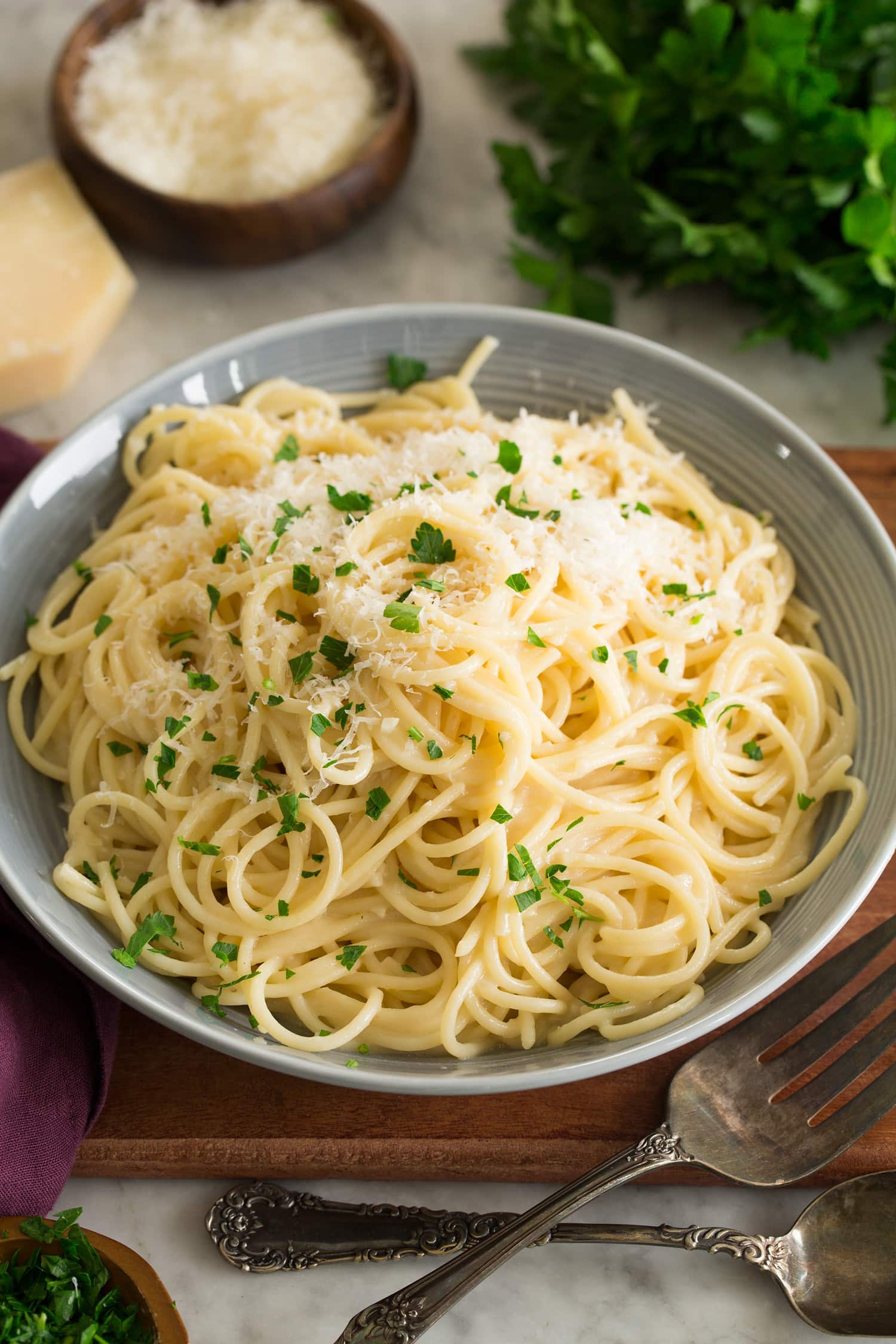 Garlic Parmesan Pasta Garlilc Parmesan pasta served in a gray pasta bowl over a wooden tray.