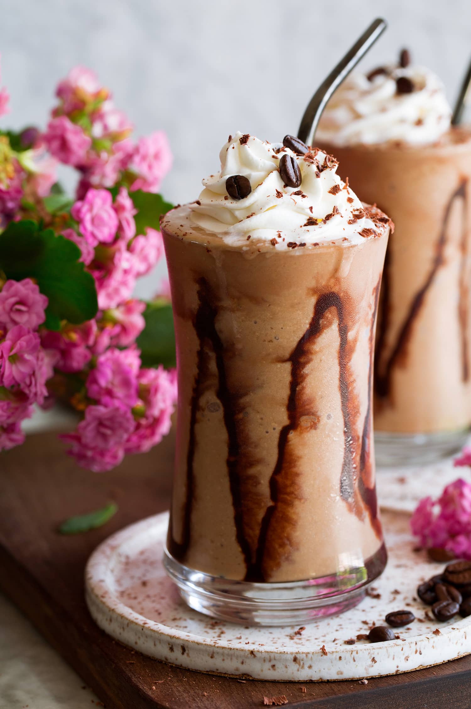 Coffee Smoothie Close up photo of coffee smoothie with streaks of chocolate sauce on glass and whipped cream topping.
