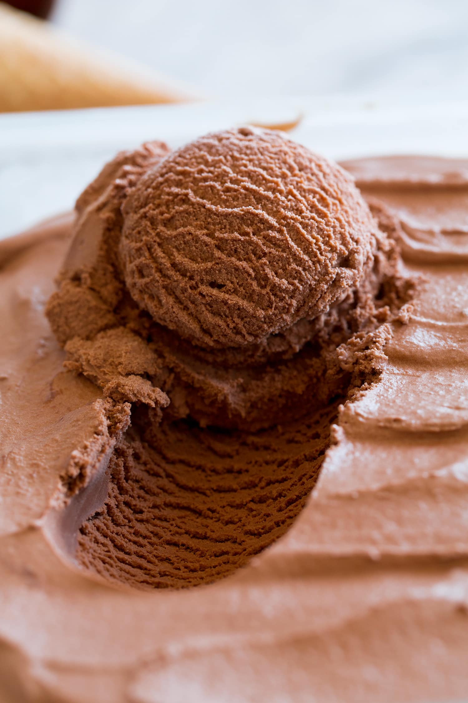 Homemade Chocolate Ice Cream Close up photo of chocolate ice cream scooped from container.