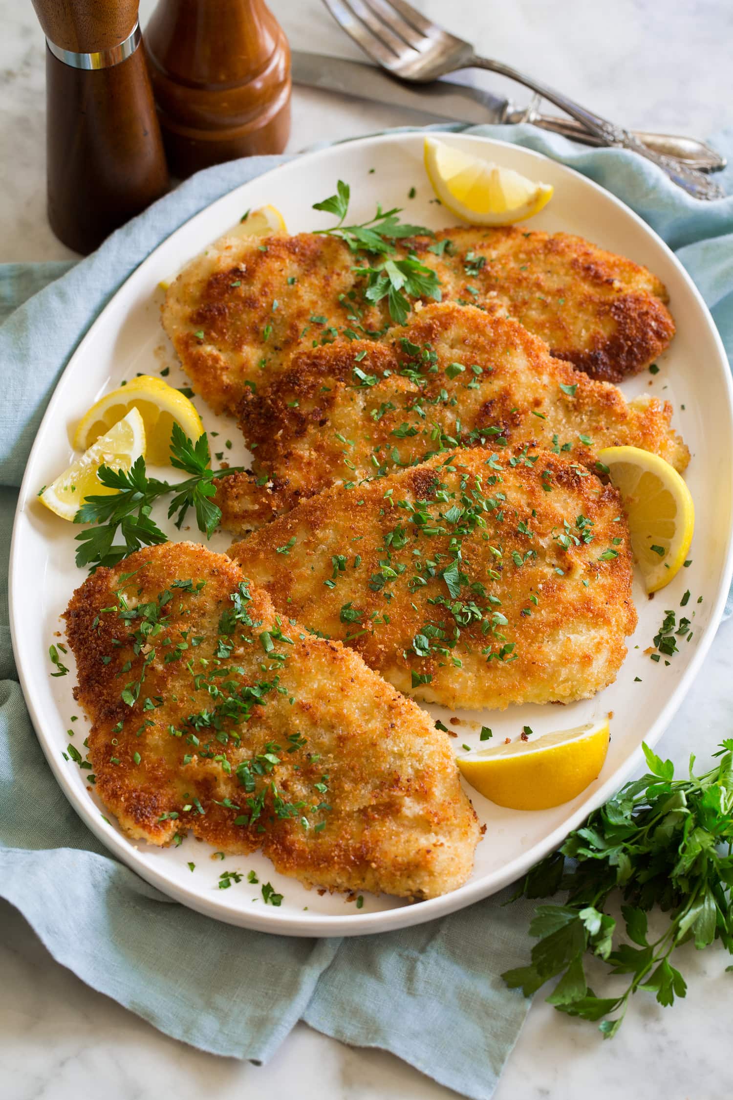 Chicken Schnitzel Tray with four servings of flattened and breaded golden brown chicken schnitzel.