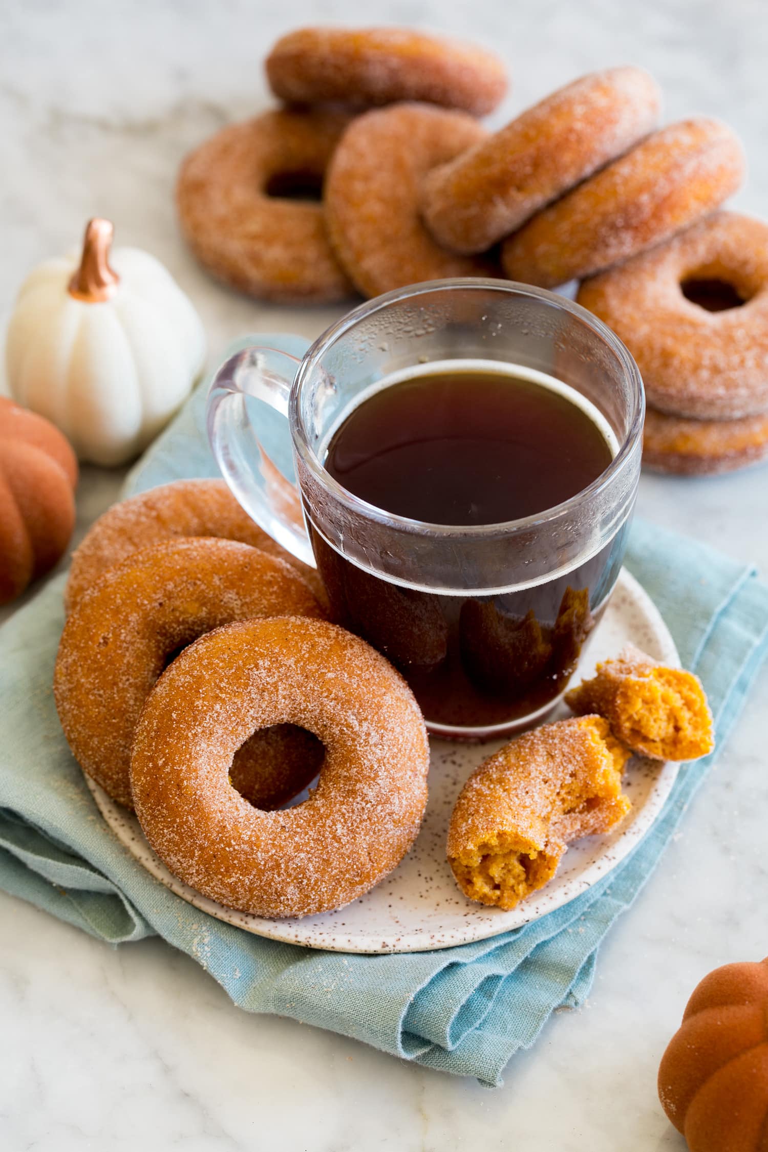Pumpkin Donuts Baked donuts served with a cup of coffee.