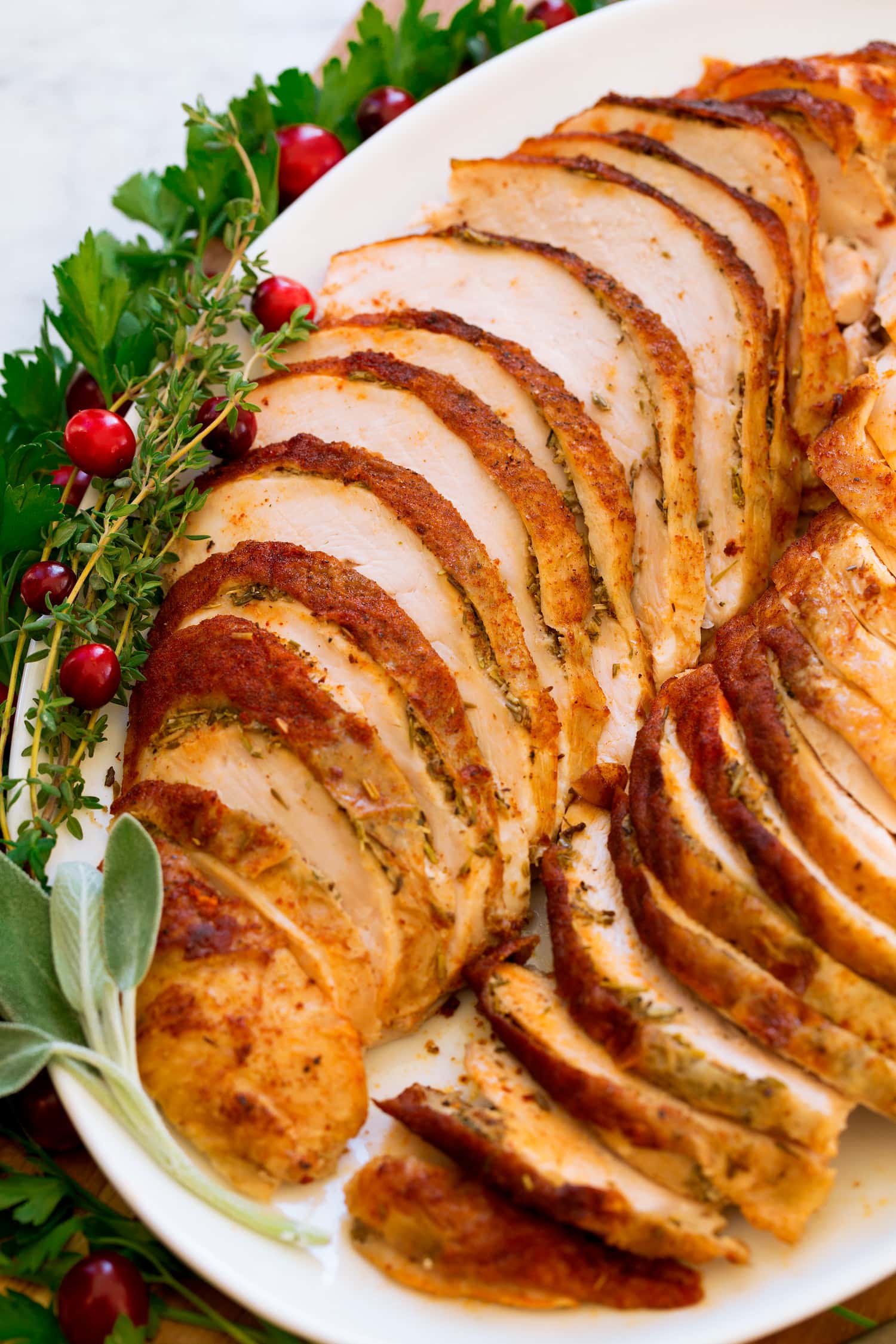 Crockpot Turkey Breast Close up photo of cooked crockpot turkey breast with herbs.
