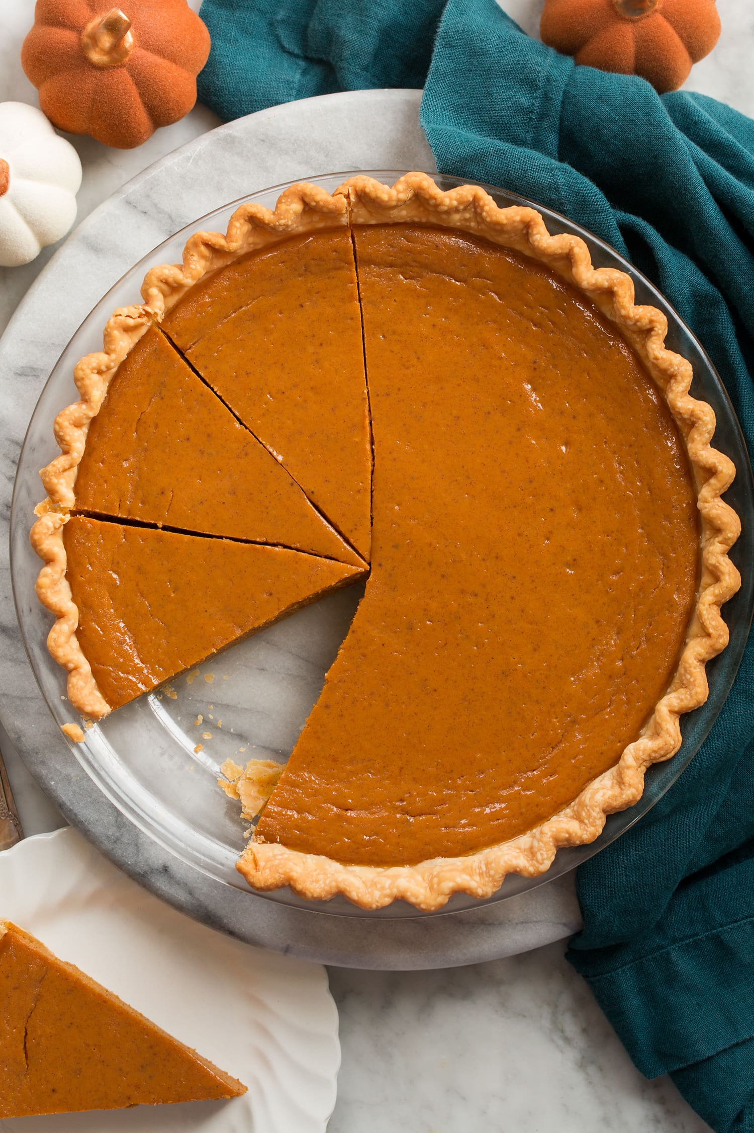 Easy Pumpkin Pie Overhead image of pumpkin pie in pie pan sliced.
