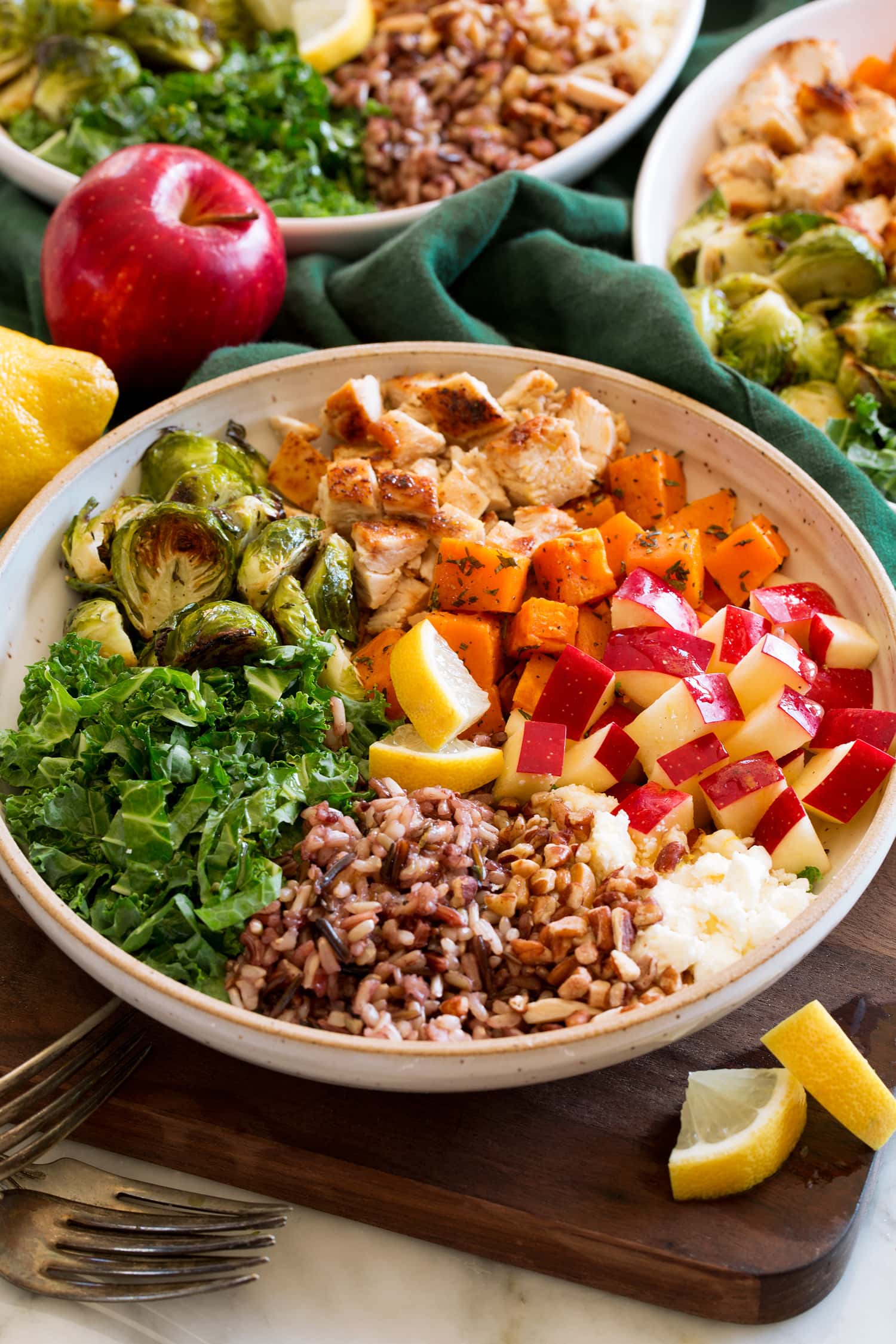 Harvest Bowl Sweet green harvest bowl copycat single serving with sweet potatoes, kale, apples, chicken, wild rice, goat cheese, and lemon dressing.