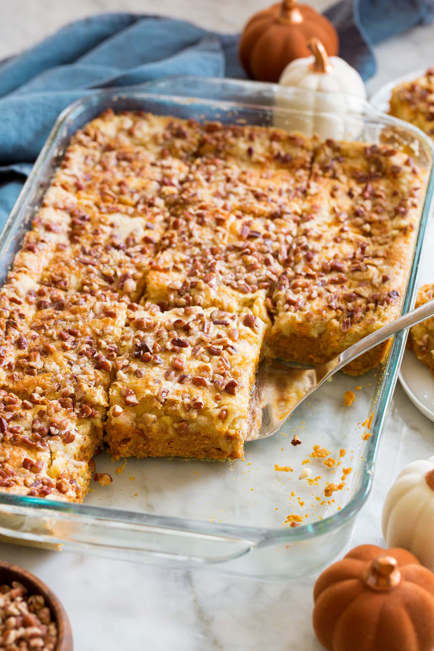 Pumpkin Dump Cake Sliced pumpkin dump cake in glass baking dish.