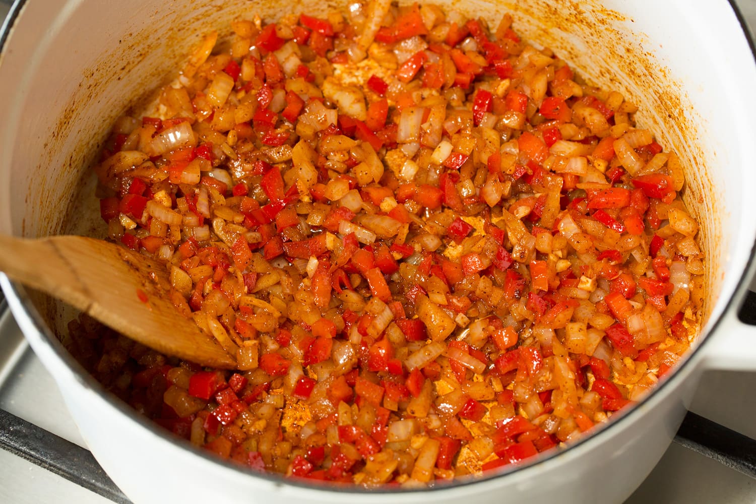 Black Bean Soup Cooked chopped peppers and onions with spices in a pot.