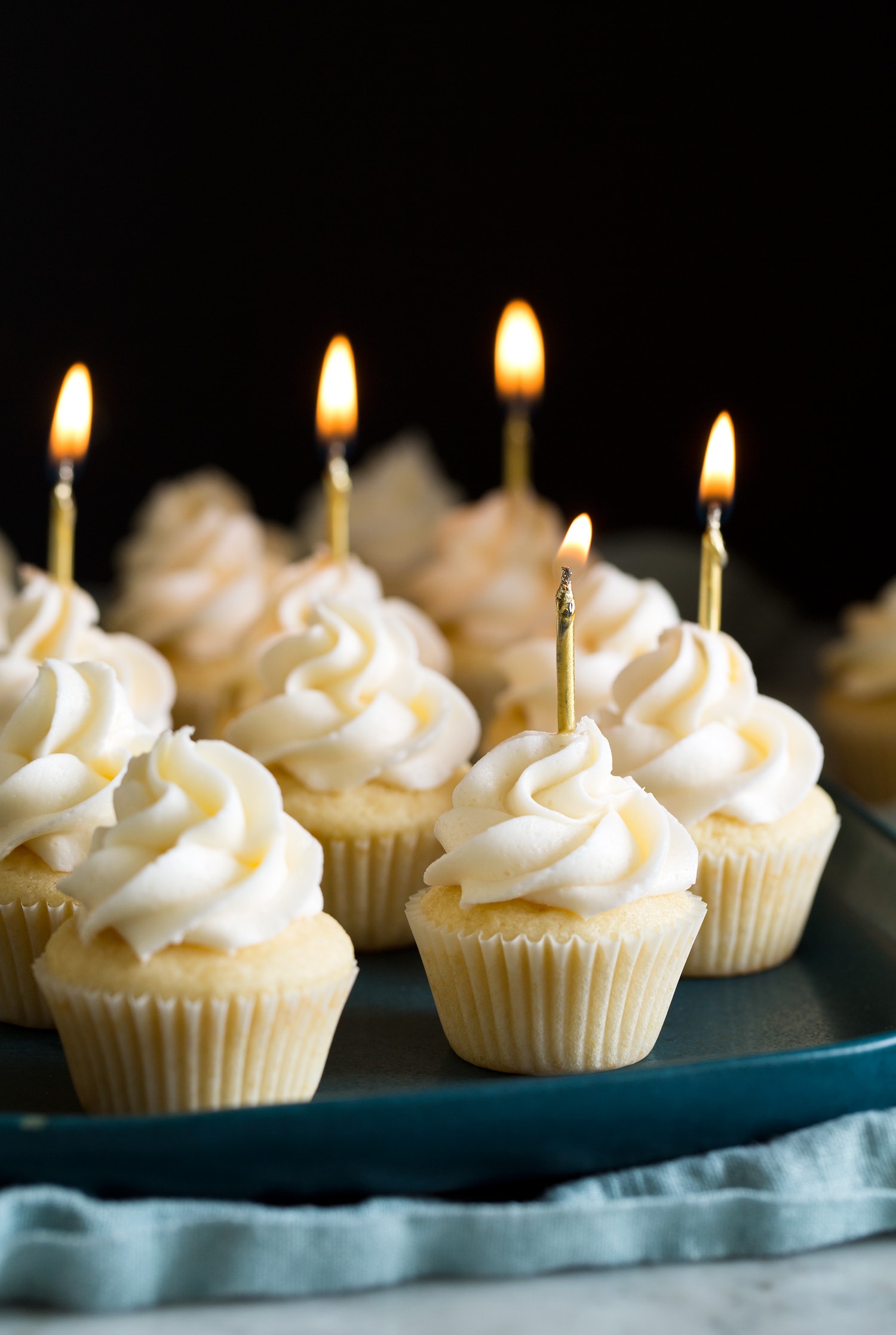 Mini Cupcakes Mini cupcakes with mini lit birthday candles.
