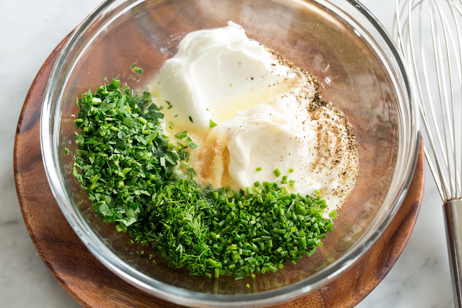 Pea Salad Making creamy pea salad dressing, shown before mixing in a glass bowl.