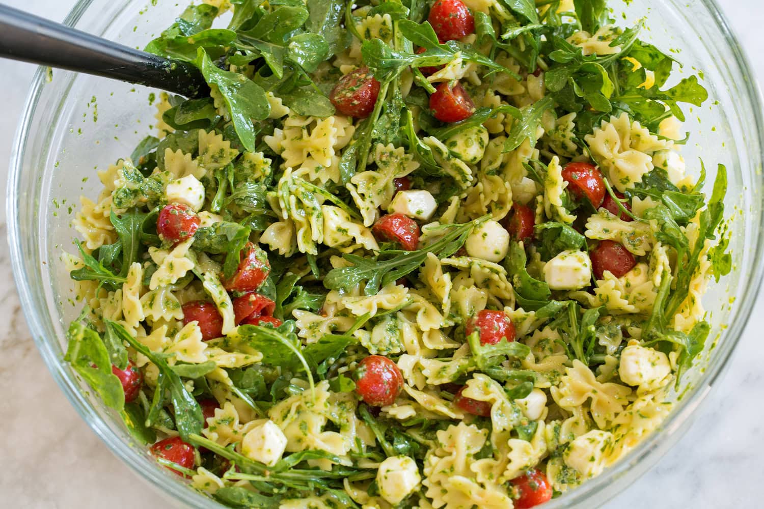 Pesto Pasta Salad Pesto pasta salad shown after mixing.