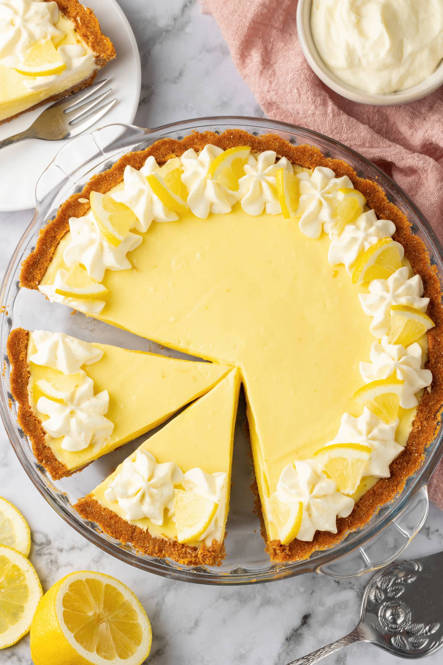 Lemon Icebox Pie Lemon icebox pie shown from above. Two slices are cut from whole pie.