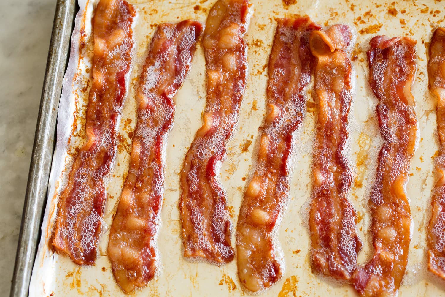 Grilled Chicken Salad Cooked bacon on a baking sheet.