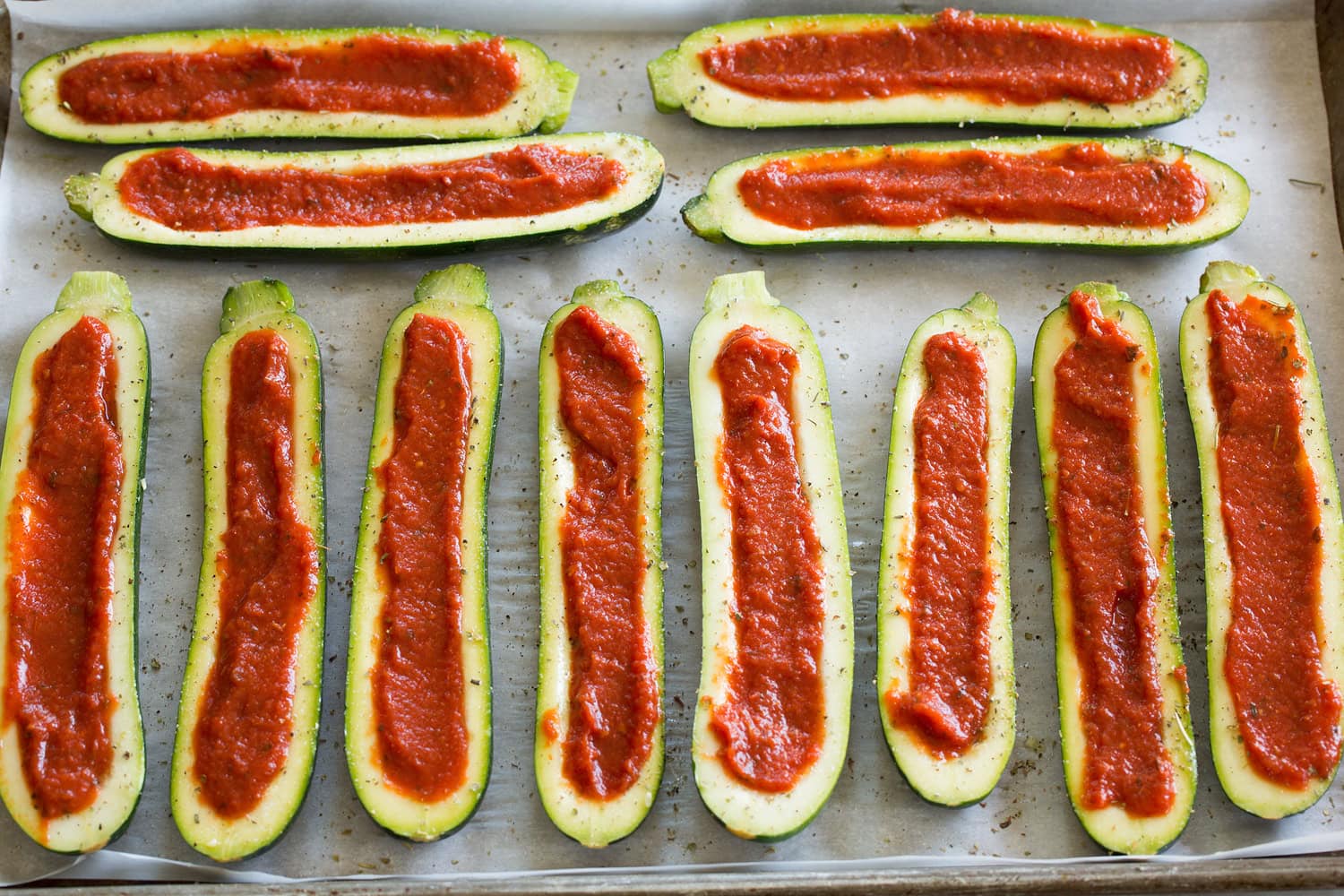 Zucchini Pizza Boats Zucchini portions with a pizza sauce filled center.