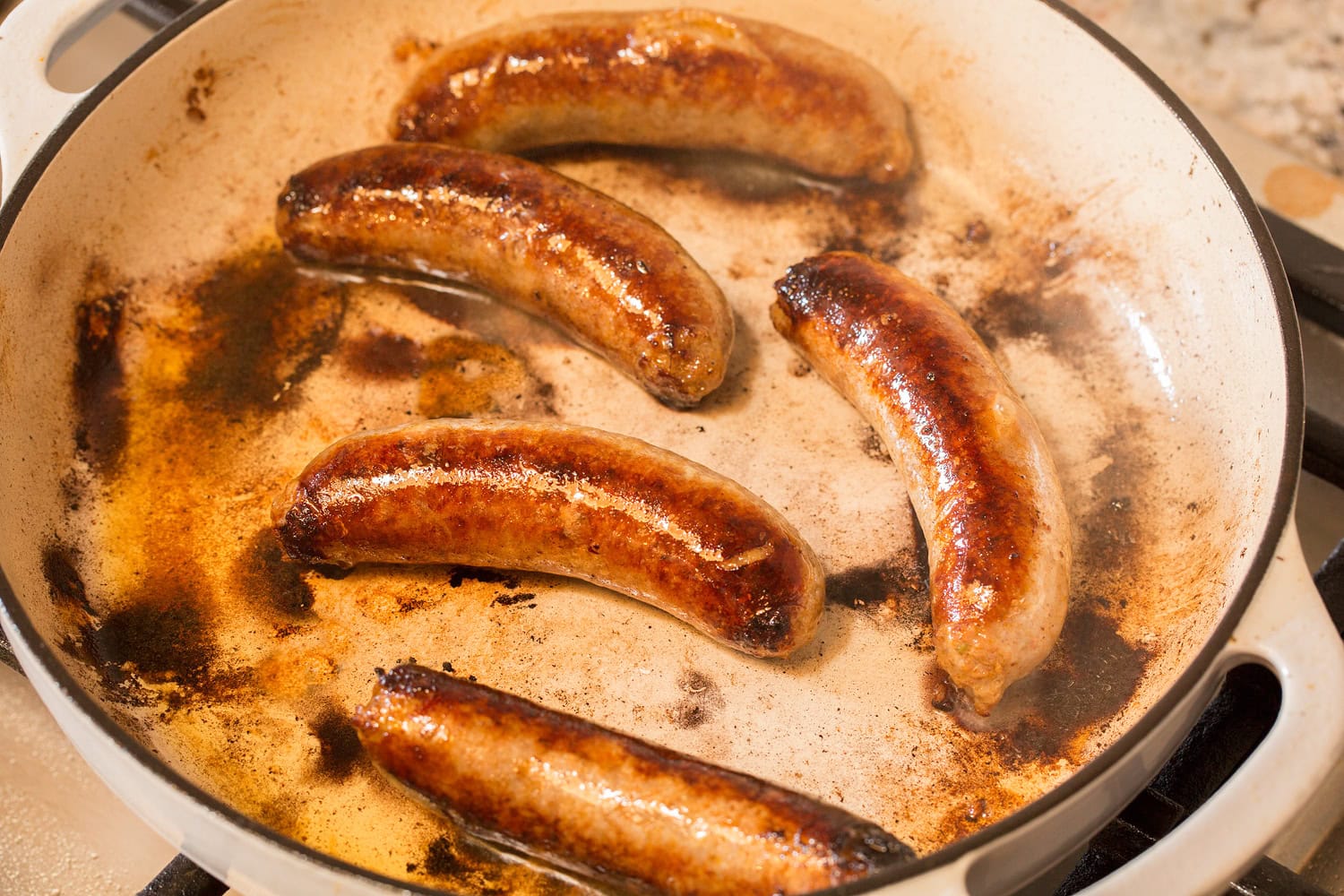 Italian Sausage Peppers and Onions Italian sausage links shown in skillet after browning.