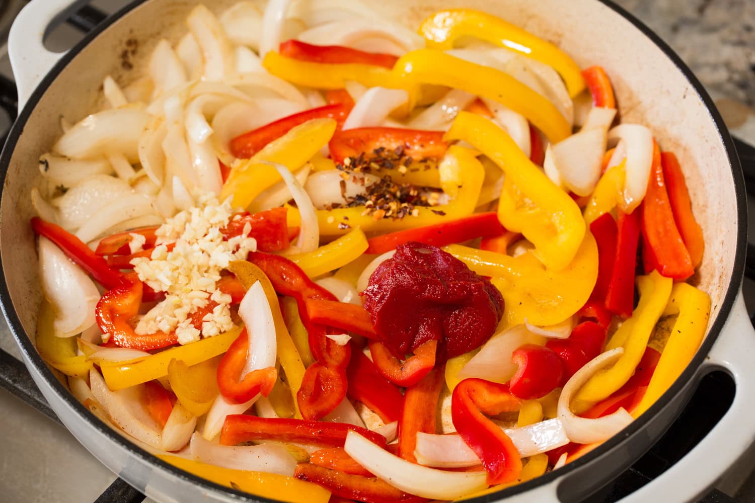Italian Sausage Peppers and Onions Peppers and onions shown sauteed with tomato paste, garlic and red pepper flakes added.