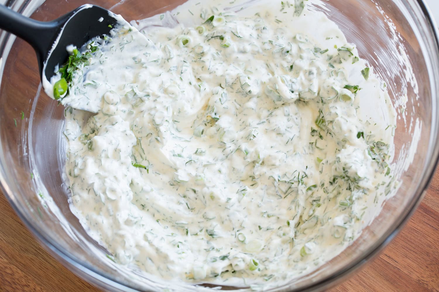 Red Potato Salad Mixed dressing for potato salad in a mixing bowl.