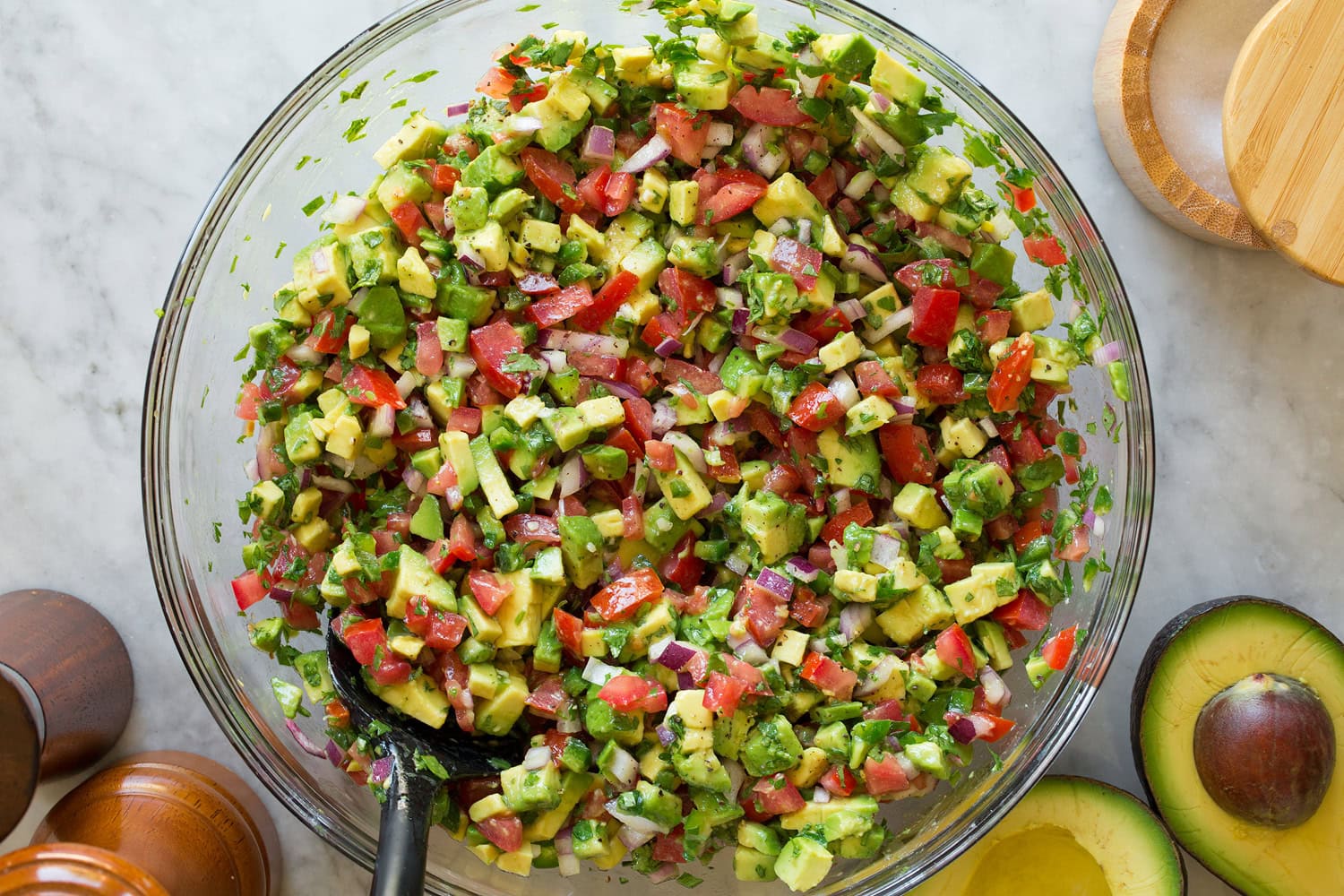 Avocado Salsa Avocado salsa in a glass mixing bowl shown after tossing ingredients together.