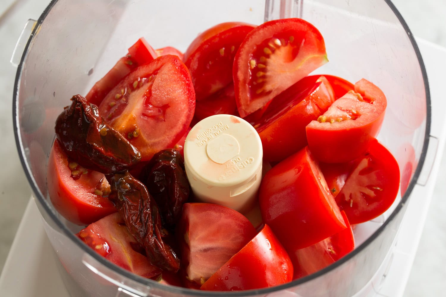 Huevos Rancheros Quartered tomatoes in food processor before mincing.