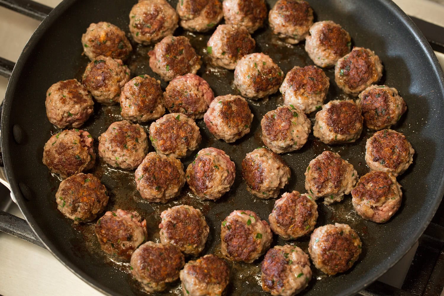 Meatball Soup Meatballs in skillet after being browned.